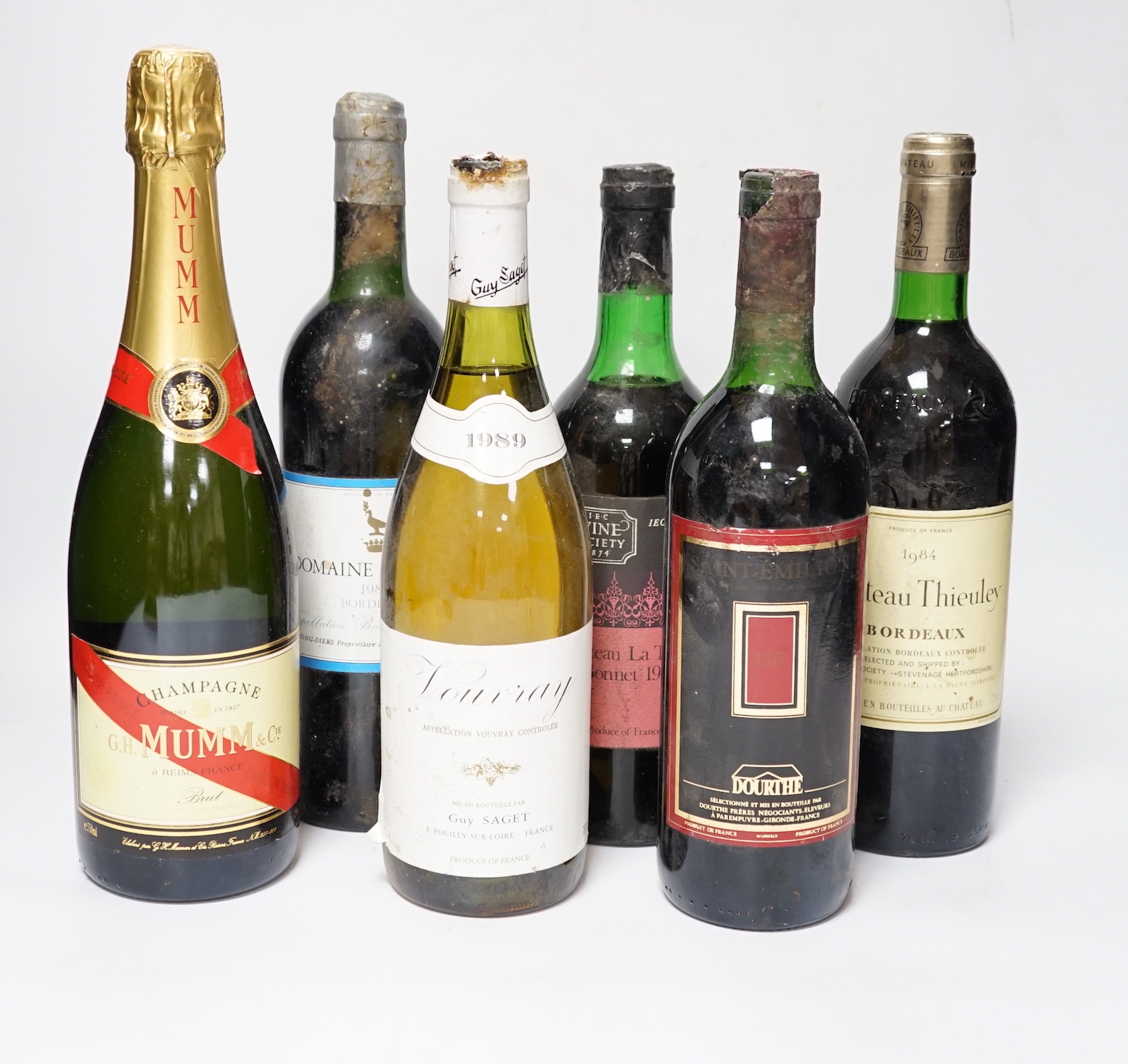 Five various bottles of wine to include Chateau La Tour St. Bonnet 1972, Vouvray 1989, Domaine La Grave 1984, Saint Emilion, Chateau Thieuley 1984 and a bottle of Mumm Champagne